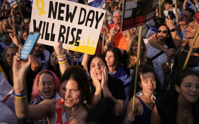 Israelis react as they gather to watch a live broadcast of Israeli hostages released from Gaza at Hostages Square in Tel Aviv, Israel, October 13, 2025. (AP Photo/Oded Balilty)